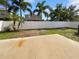 Backyard featuring a large concrete patio surrounded by lush green palm trees at 3444 97Th E Ln, Palmetto, FL 34221