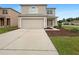 Inviting two-story home with a two car garage, manicured lawn, and neutral toned facade at 3444 97Th E Ln, Palmetto, FL 34221