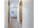 Hallway featuring arched doorways and carpet flooring leading to other areas of the home at 3444 97Th E Ln, Palmetto, FL 34221