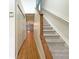 Hallway with hardwood floors leading to carpeted staircase at 3444 97Th E Ln, Palmetto, FL 34221