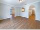Open-concept living space with arched doorways and laminate wood flooring at 3444 97Th E Ln, Palmetto, FL 34221