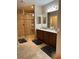 A bathroom features a stand up tiled shower and double sink vanity at 23598 Awabuki Dr # 102, Venice, FL 34293