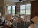 A dining area with water view features a round table and light color chairs at 23598 Awabuki Dr # 102, Venice, FL 34293