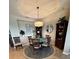A formal dining room featuring a large round table and decorative furnishings at 23598 Awabuki Dr # 102, Venice, FL 34293
