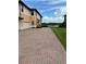 Charming exterior of a home featuring a brick driveway, well-maintained lawn, and picturesque water views at 23598 Awabuki Dr # 102, Venice, FL 34293
