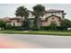 Charming two-story home with lush landscaping and a tile roof at 23598 Awabuki Dr # 102, Venice, FL 34293