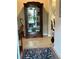 Welcoming foyer featuring tile floors, a display cabinet, and tasteful decor at 23598 Awabuki Dr # 102, Venice, FL 34293