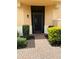 Inviting front entrance with a brick pathway and manicured bushes at 23598 Awabuki Dr # 102, Venice, FL 34293