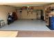 Spacious two-car garage with epoxy flooring, shelving, storage, and room for vehicles and projects at 23598 Awabuki Dr # 102, Venice, FL 34293