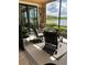 Screened lanai with patio furniture, plants, and sliding glass doors provides indoor/outdoor living space at 23598 Awabuki Dr # 102, Venice, FL 34293