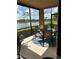 Relax and dine outdoors on this screened lanai, complete with patio set and views of the lake at 23598 Awabuki Dr # 102, Venice, FL 34293