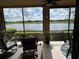 Screened lanai featuring beautiful lake views, comfortable seating, and a ceiling fan for relaxing outdoors at 23598 Awabuki Dr # 102, Venice, FL 34293