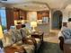 Comfortable living room featuring warm lighting, wood cabinets and decor at 23598 Awabuki Dr # 102, Venice, FL 34293