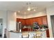 Kitchen with wood cabinets, island, and stainless steel appliances at 17274 Asmara Ct, Punta Gorda, FL 33955