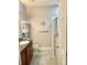 Bathroom with tiled floor, shower, and wood cabinets at 17274 Asmara Ct, Punta Gorda, FL 33955
