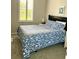 Bedroom with a bed, nightstand, and window with shutters at 17274 Asmara Ct, Punta Gorda, FL 33955