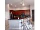 Kitchen with wood cabinets, island, and stainless steel appliances at 17274 Asmara Ct, Punta Gorda, FL 33955