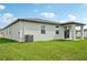 Backyard featuring manicured lawn and covered porch and stucco siding at 145 Lazy Shore Dr, Nokomis, FL 34275
