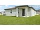 Expansive backyard featuring a covered patio and lush green lawn, ideal for outdoor entertaining and relaxation at 145 Lazy Shore Dr, Nokomis, FL 34275