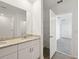 Well-lit bathroom featuring double sinks, granite countertops, and a walk-in shower for a luxurious feel at 145 Lazy Shore Dr, Nokomis, FL 34275