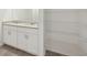 Bright bathroom featuring a dual vanity with granite countertops and a shelved walk-in closet at 145 Lazy Shore Dr, Nokomis, FL 34275