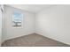 Bright bedroom features plush carpet, a large window, and neutral walls at 145 Lazy Shore Dr, Nokomis, FL 34275