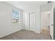 Neutral bedroom featuring carpeted floors and a double door closet at 145 Lazy Shore Dr, Nokomis, FL 34275