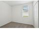 Bright bedroom featuring plush carpet and a window overlooking the neighborhood at 145 Lazy Shore Dr, Nokomis, FL 34275