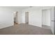 Spacious bedroom with neutral carpet and white walls, showcasing ample natural light and multiple doorways at 145 Lazy Shore Dr, Nokomis, FL 34275