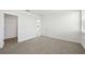 A bright bedroom features neutral carpet, walk-in closet, and white walls at 145 Lazy Shore Dr, Nokomis, FL 34275