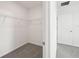 Bright walk-in closet with shelving and neutral carpeting in this modern home at 145 Lazy Shore Dr, Nokomis, FL 34275