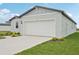 Light-colored single Gathering home with a two car garage, manicured lawn and blue sky at 145 Lazy Shore Dr, Nokomis, FL 34275
