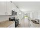 Bright kitchen features stainless appliances, granite countertops, white cabinets and eat in space overlooking the backyard at 145 Lazy Shore Dr, Nokomis, FL 34275