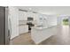 Open kitchen featuring stainless appliances, granite countertops, white cabinets and a center island with a sink at 145 Lazy Shore Dr, Nokomis, FL 34275
