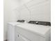 Dedicated laundry area featuring a side-by-side washer and dryer set, with wire shelving for storage at 145 Lazy Shore Dr, Nokomis, FL 34275