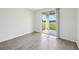 Bright living room with neutral tile flooring and sliding glass doors leading to the outdoor space at 145 Lazy Shore Dr, Nokomis, FL 34275