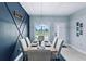 Modern dining room with a statement wall and large window at 27367 Chinquapin Dr, Punta Gorda, FL 33955