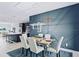 Modern dining room with a statement wall and kitchen view at 27367 Chinquapin Dr, Punta Gorda, FL 33955