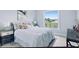 Bright bedroom with window overlooking tranquil water views at 27367 Chinquapin Dr, Punta Gorda, FL 33955