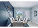 Modern dining room with a statement wall and large window at 27367 Chinquapin Dr, Punta Gorda, FL 33955