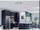 Open concept kitchen with dark cabinetry and island at 27367 Chinquapin Dr, Punta Gorda, FL 33955