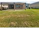 Large backyard with grass and a wooden pergola at 12545 Ryegrass Loop, Parrish, FL 34219