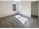 Bright bedroom with grey carpet and a large window at 12545 Ryegrass Loop, Parrish, FL 34219