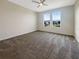 Spacious bedroom with neutral carpeting and large windows offering natural light at 12545 Ryegrass Loop, Parrish, FL 34219