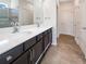 Double vanity bathroom with a walk-in shower at 12545 Ryegrass Loop, Parrish, FL 34219