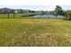 Spacious backyard with a pond and a fence at 12545 Ryegrass Loop, Parrish, FL 34219