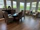 Elegant dining room with hardwood floors and a glass-top dining table at 5520 Limelight Dr, Apollo Beach, FL 33572