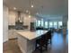 Modern kitchen with white cabinets, quartz countertops and an island at 5520 Limelight Dr, Apollo Beach, FL 33572