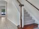 Elegant staircase with a wooden handrail and carpeted steps at 7904 Camden Woods Dr, Tampa, FL 33619