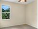 Simple bedroom with a window and neutral walls at 7904 Camden Woods Dr, Tampa, FL 33619